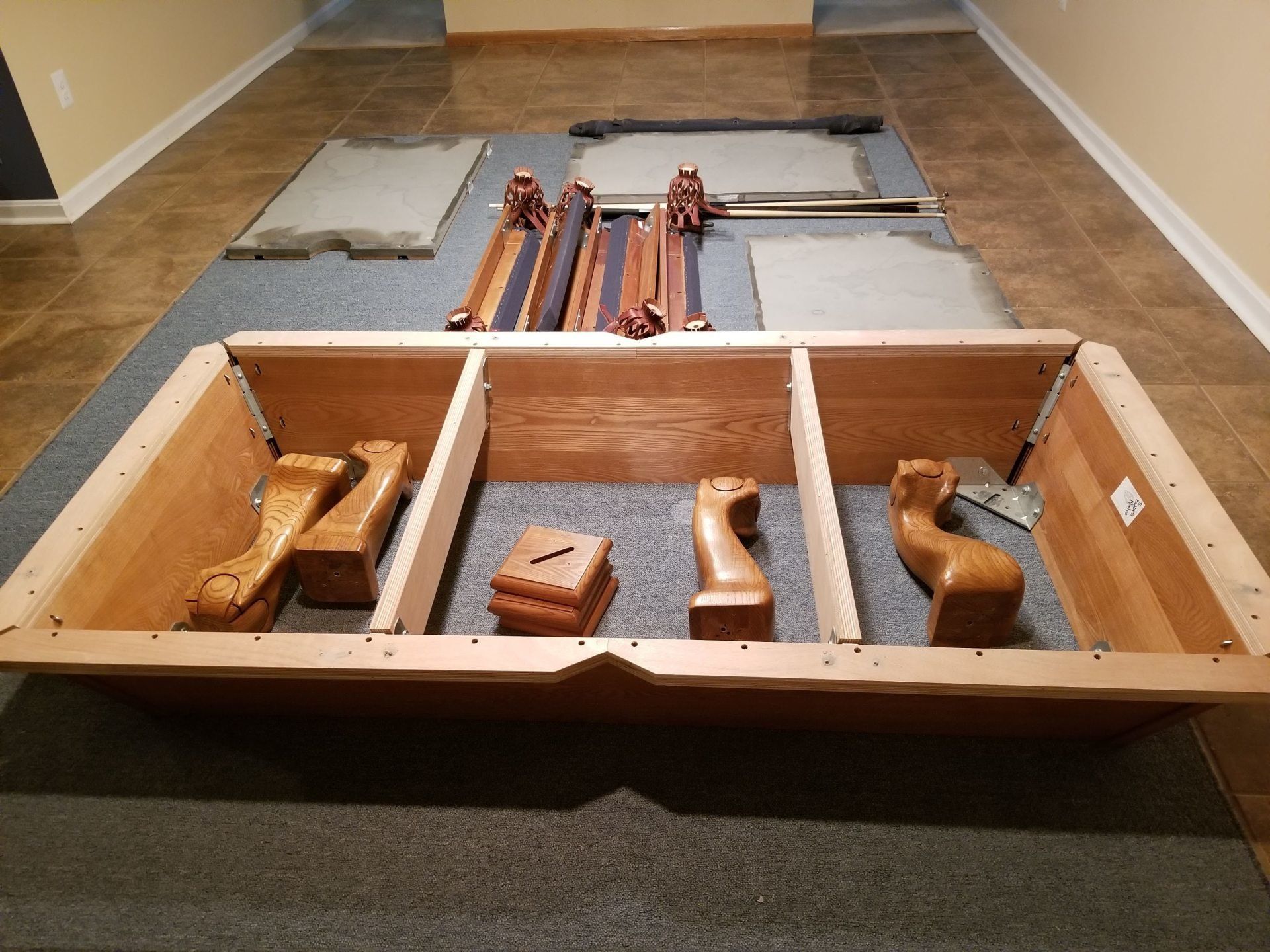 A pool table is being dismantled in a room