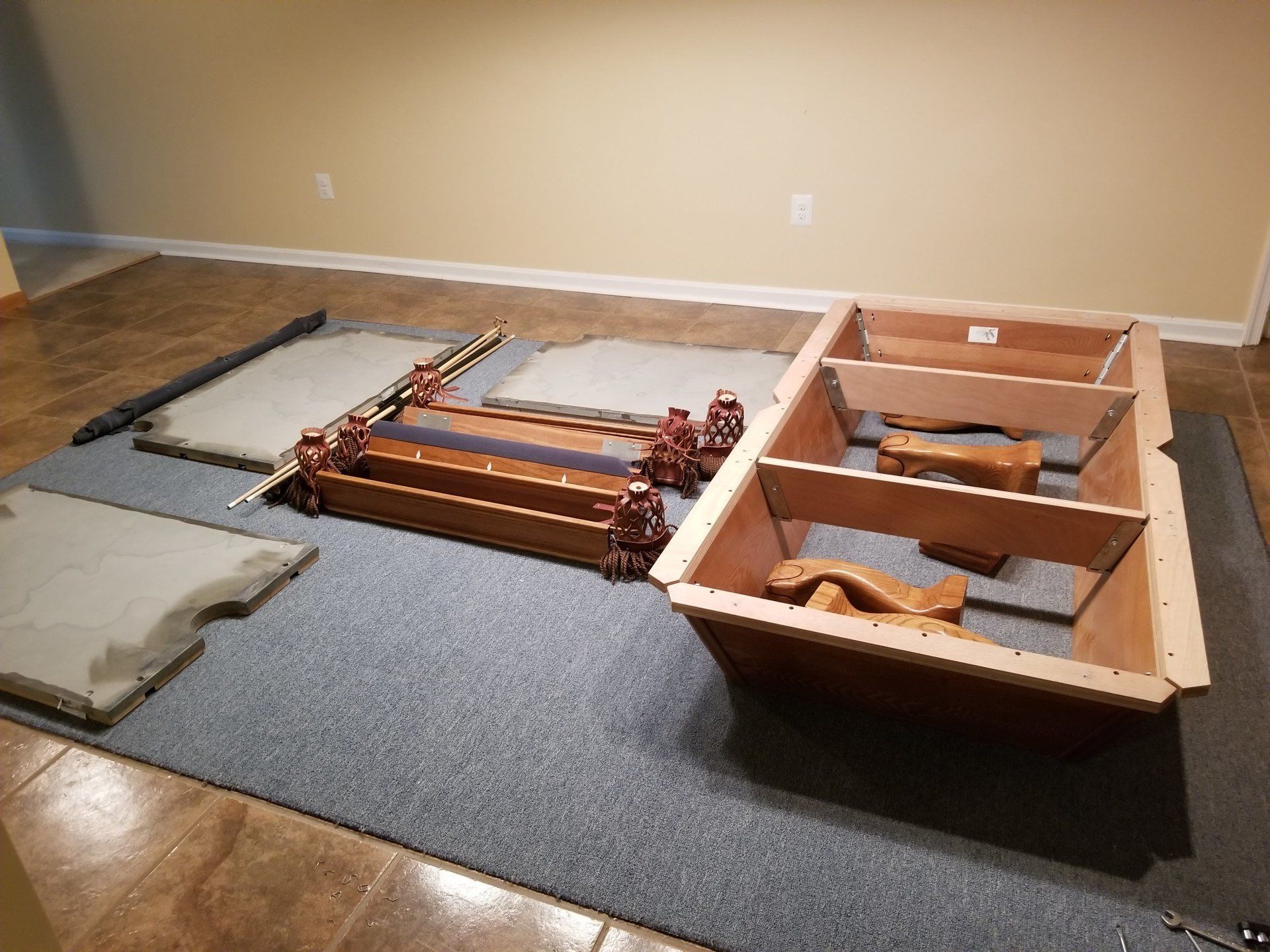 A wooden table is sitting on top of a carpet in a room.