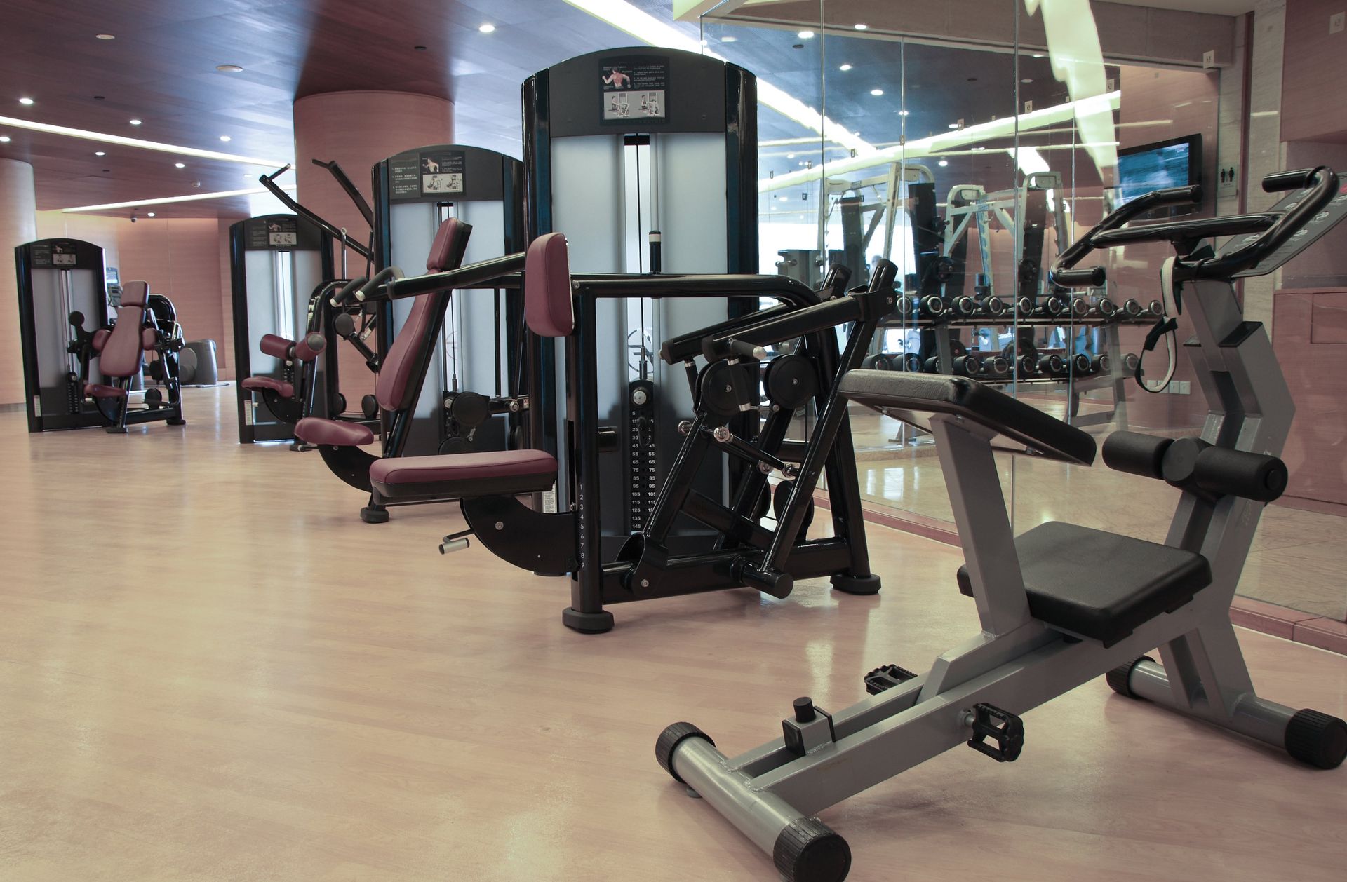 A gym with a lot of exercise equipment in it