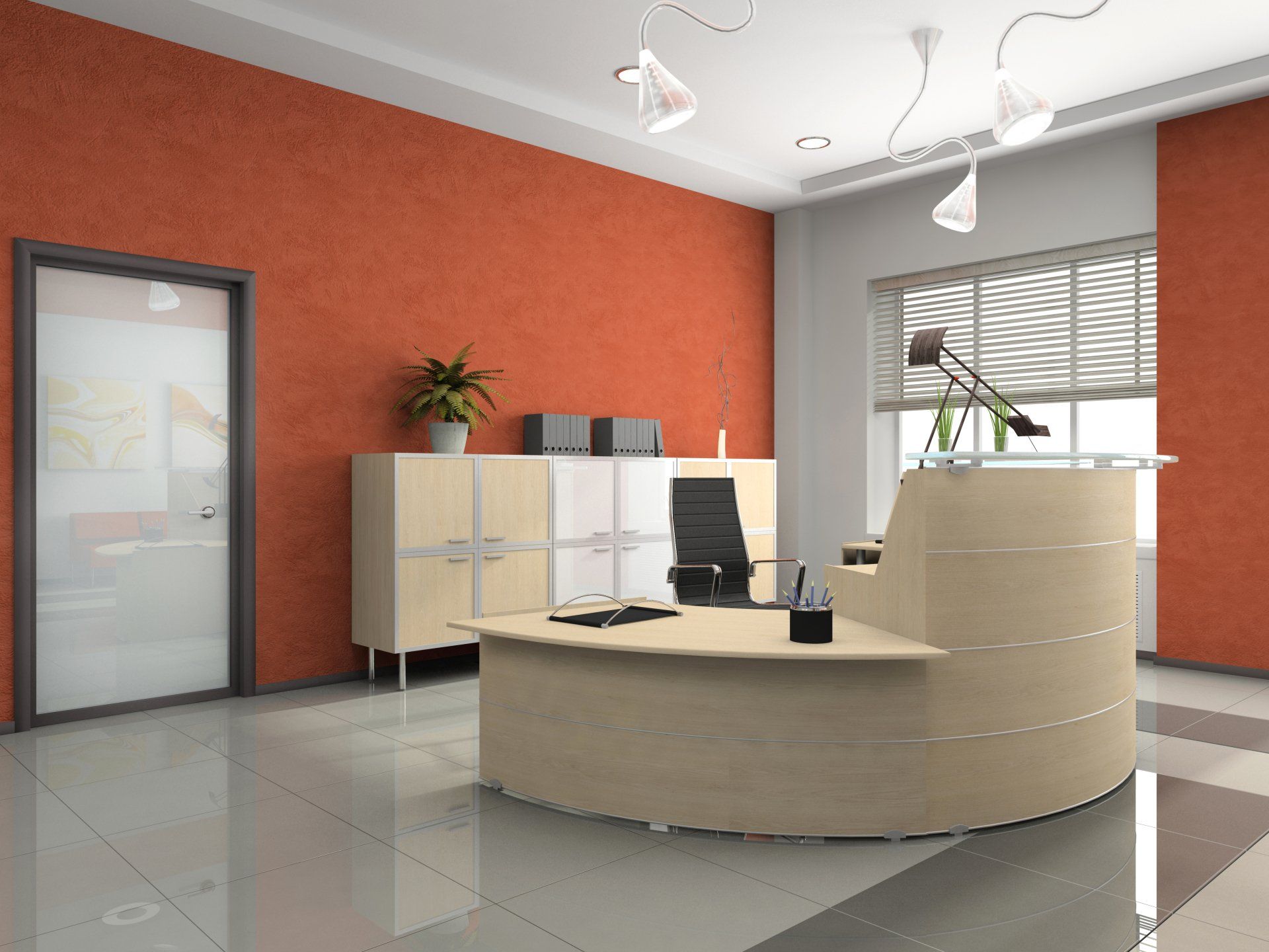 An office with a round desk and a red wall