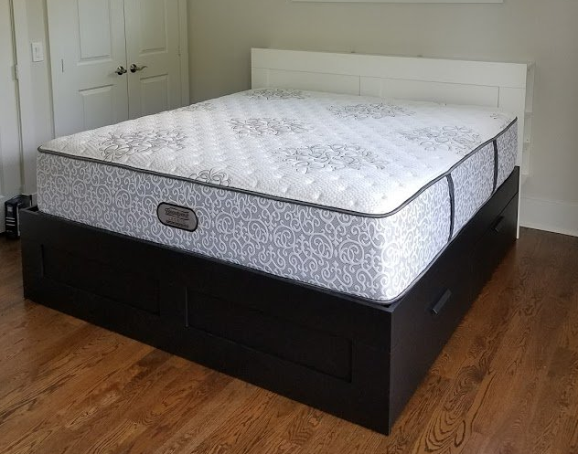 A bed with a mattress on top of it in a bedroom.