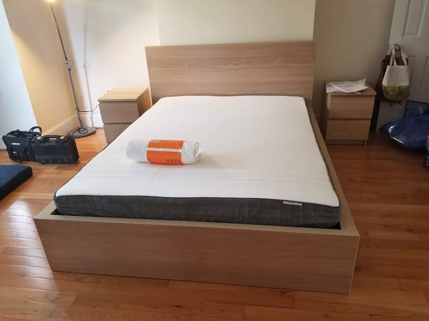 A bed with a towel on top of it in a bedroom