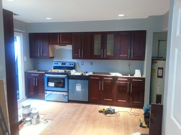 A kitchen with stainless steel appliances and wooden cabinets