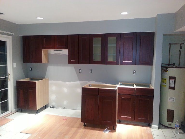 A kitchen with wooden cabinets and a water heater