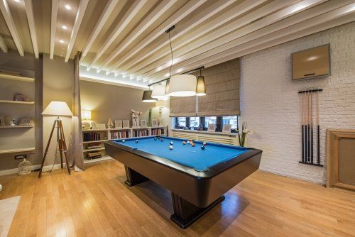 There is a pool table in the middle of the room.