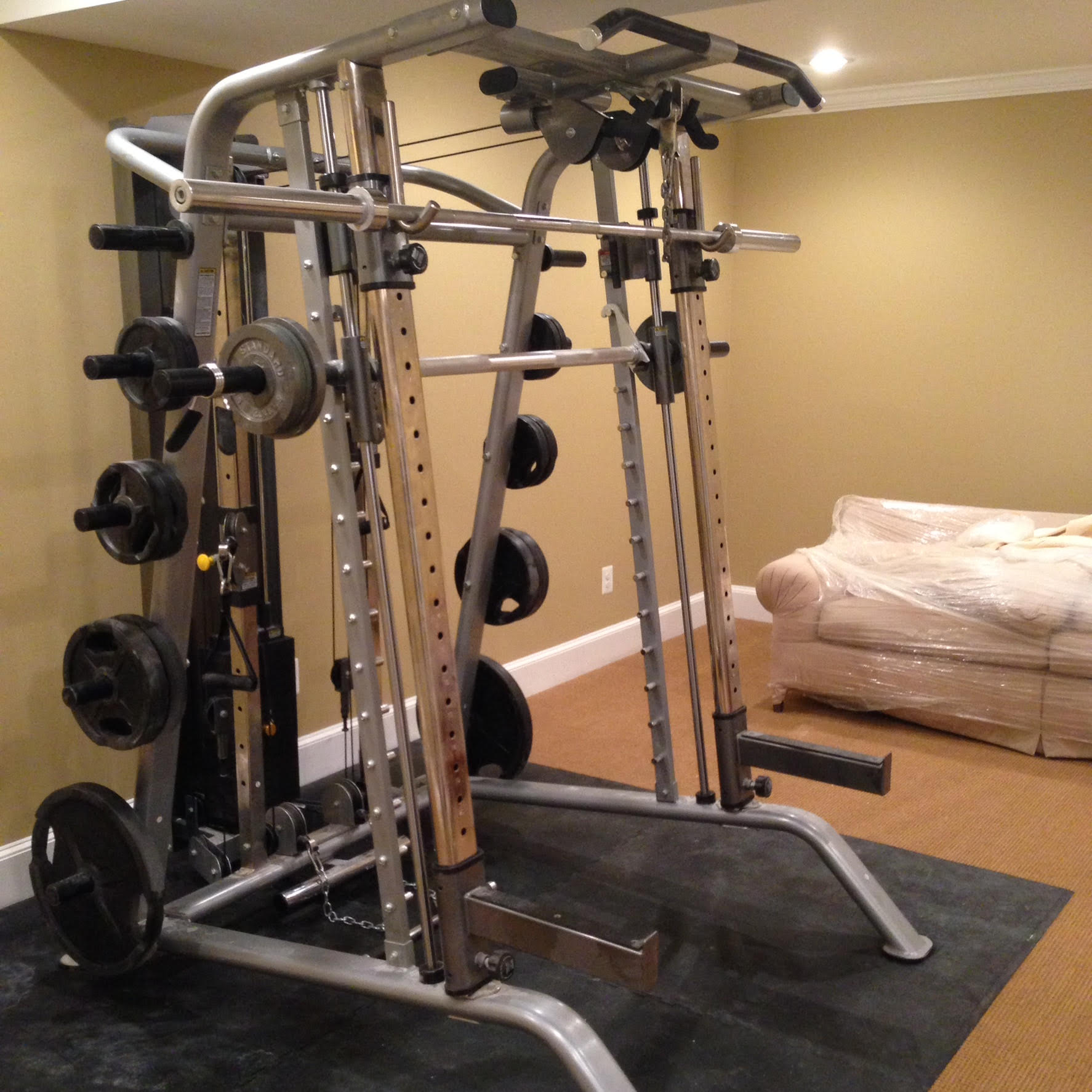 A gym with a couch and a bed in the background