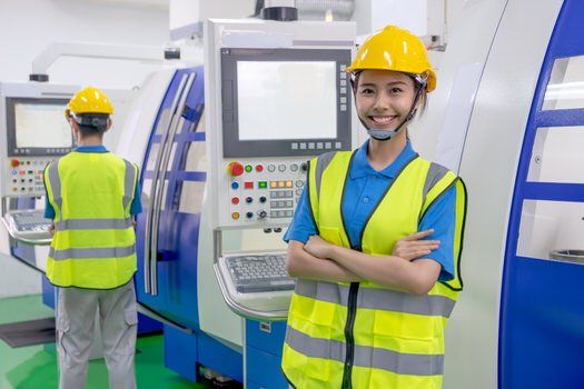Young female machine operator in a factory in Peel, Ontario.
