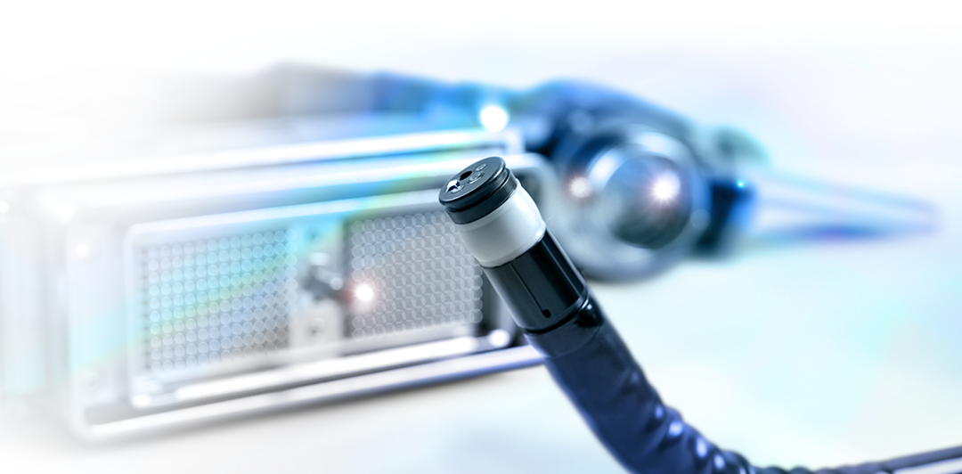 A close up of an endoscope with a projector in the background.