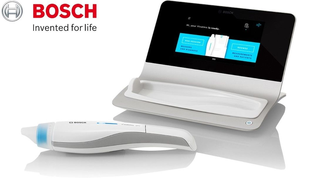 A bosch device is sitting next to a laptop