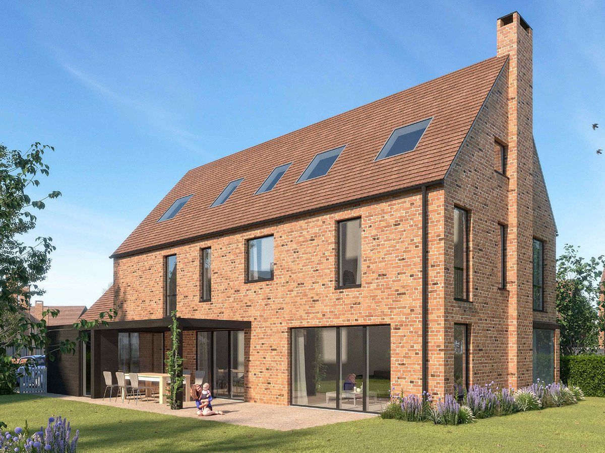 Modern brick house with large windows, steep roof, and a small garden in front