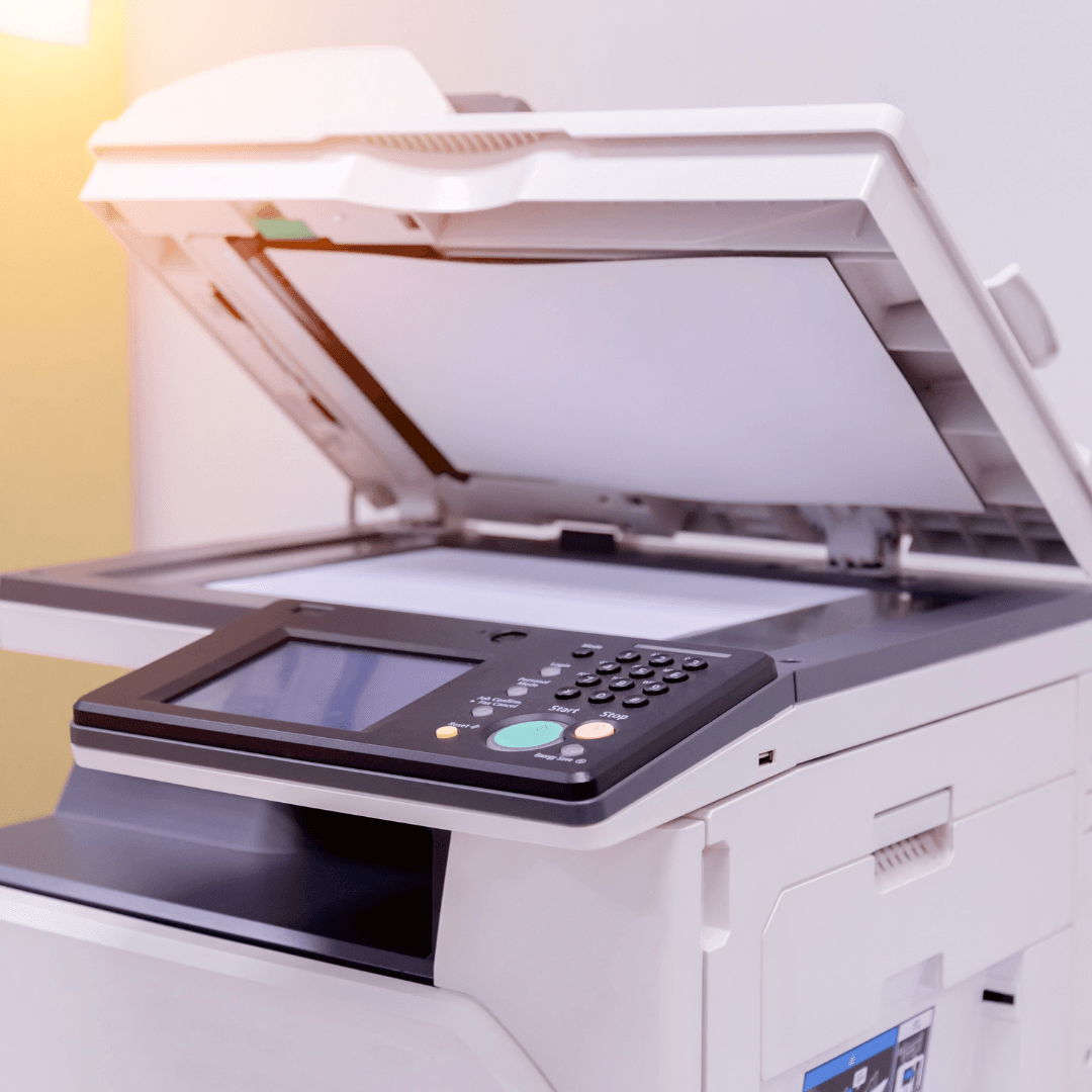 White office photocopier with scanner lid open and control panel visible