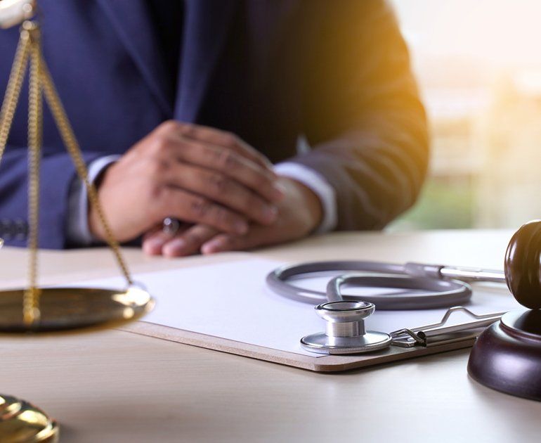 Workers Compensation Claim — Lawyer With Law Gavel And Stethoscope In Moline, IL A workers compensation lawyer who serves Rock Island, IL