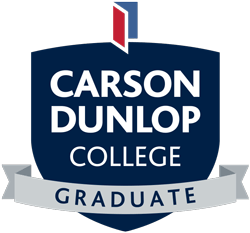 The logo for carson dunlop college graduate is a blue shield with a white ribbon.