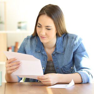 Insurance — Relaxed Lady Reading A Letter At Home in Hesperia, CA Insurance — Relaxed Lady Reading A Letter At Home in Hesperia, CA