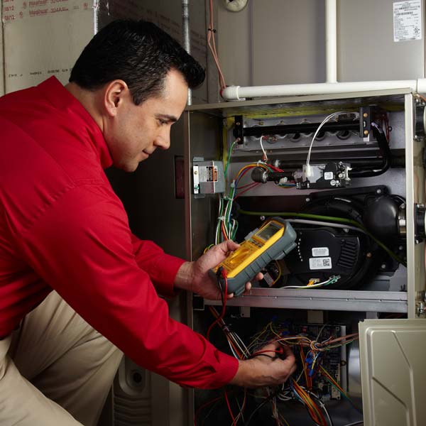 Technician inspect wiring inside an open HVAC unit | TN Property Solutions LLC - Cunningham, TN