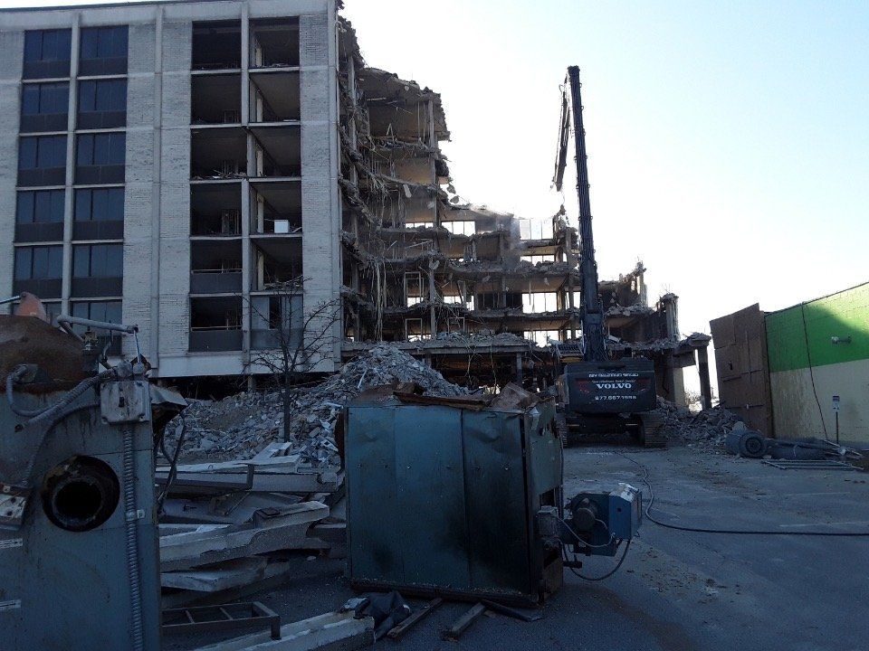Damaged multi-story building with heavy rubble and debris after a collapse or explosion