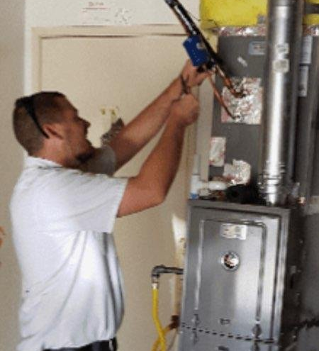 Heating Contractor — Contractor Installing Heater at House in San Dimas, CA Heating Contractor — Contractor Installing Heater at House in San Dimas, CA