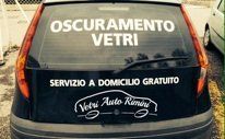 Black car rear window with white text: