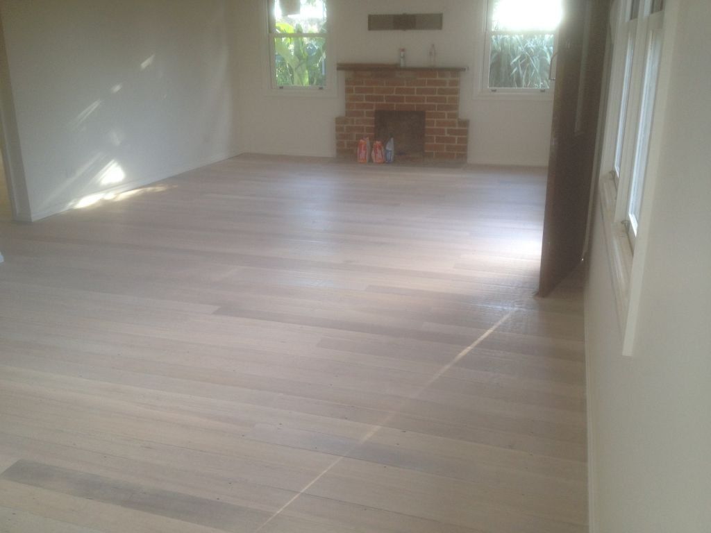 white wash finish wood flooring with fireplace