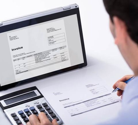 Man Writing While Using a Calculator — Ahrens & Associates, S.C. — Appleton, WI Man Writing While Using a Calculator — Ahrens & Associates, S.C. — Appleton, WI