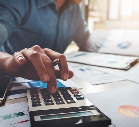 Man Using a Calculator — Ahrens & Associates, S.C. — Appleton, WI