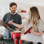 Two homeowners make dinner together.