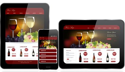 A tablet , phone , and tablet with a wine website on them.
