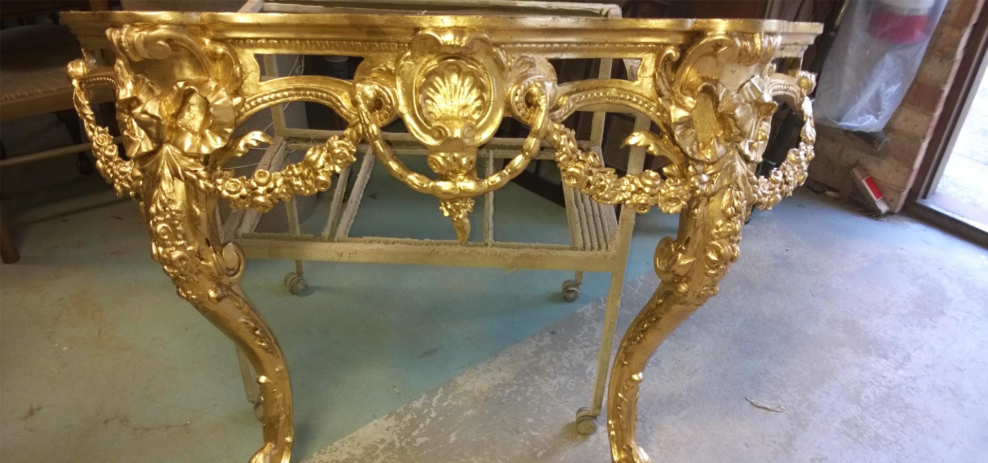 Ornate gold console table with carved details.
