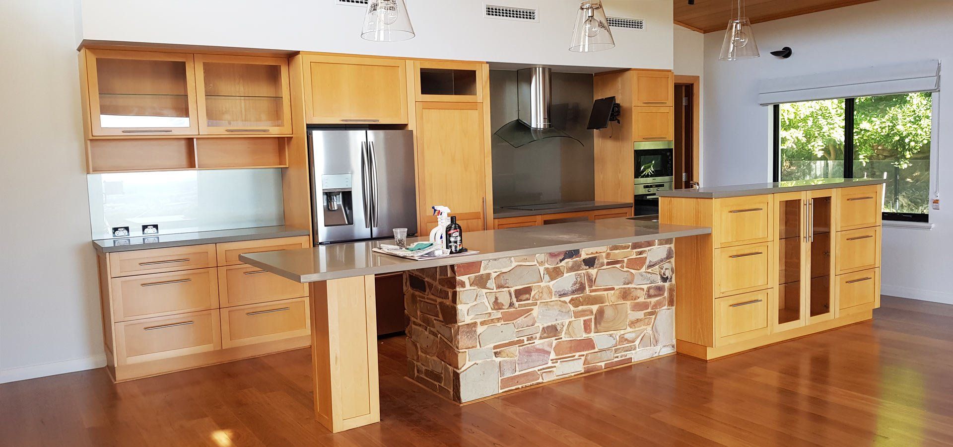Kitchen with wood cabinets and island; stainless steel appliances.
