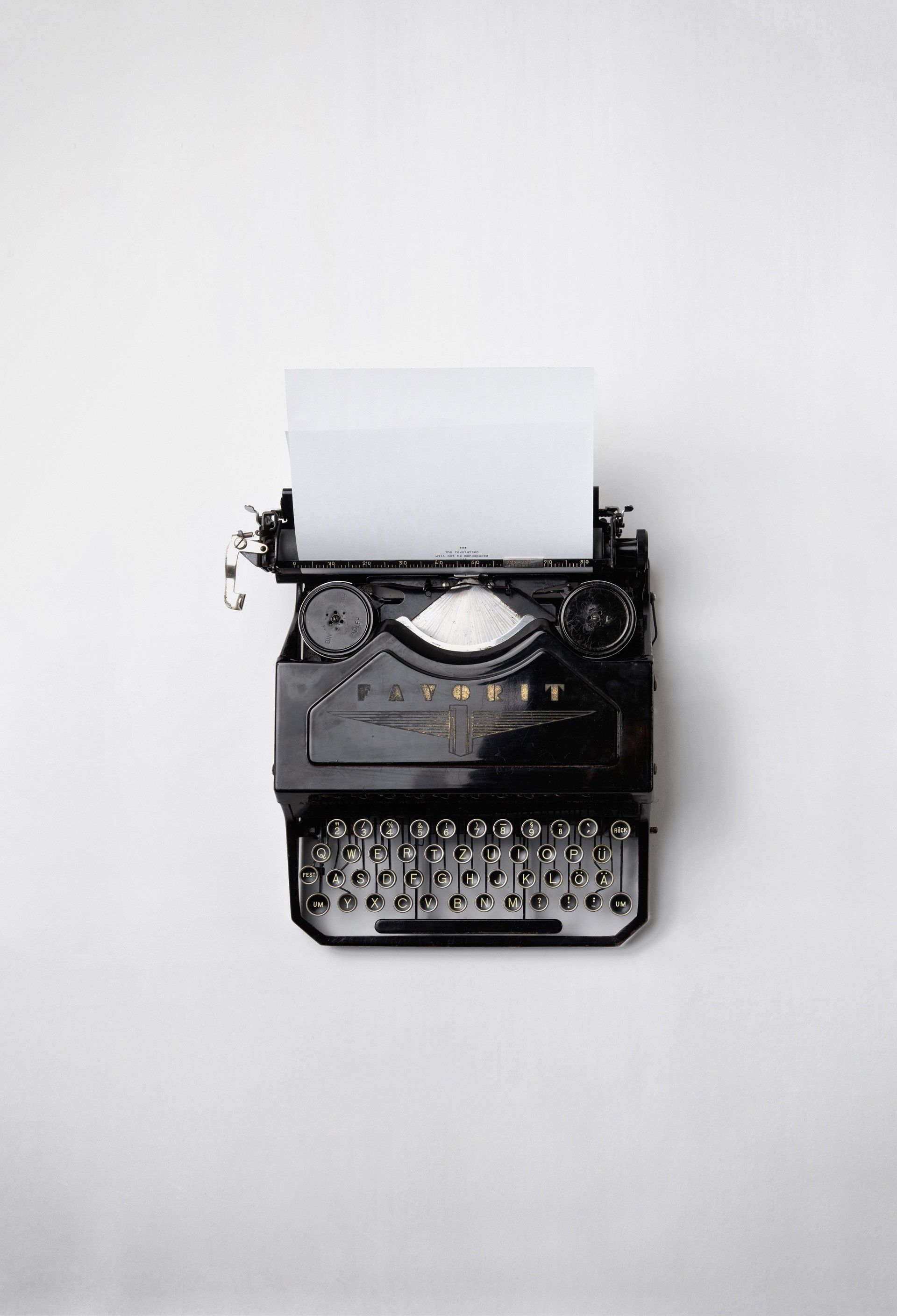 An old typewriter with a piece of paper coming out of it.
