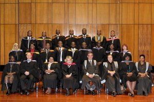 A group of people in graduation gowns are posing for a picture