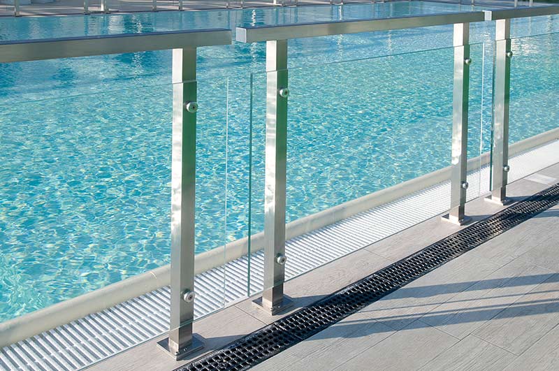 low glass wall in front of pool