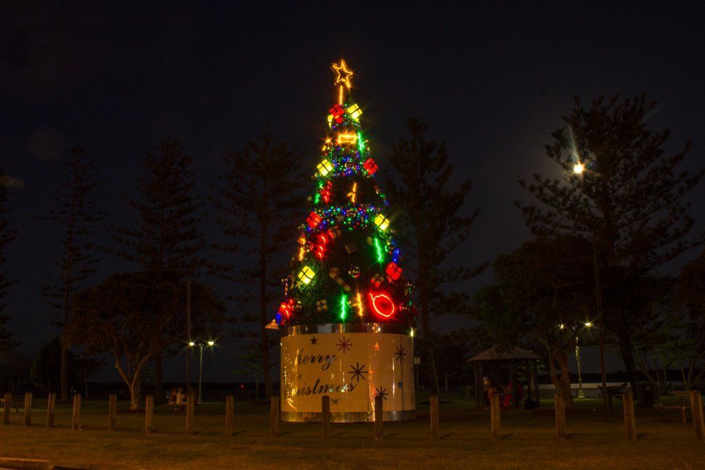 Christmas tree on stand glowing at night