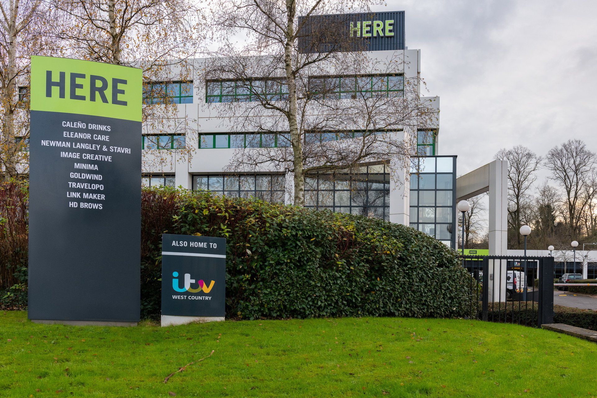 A large building with a sign that says here in front of it