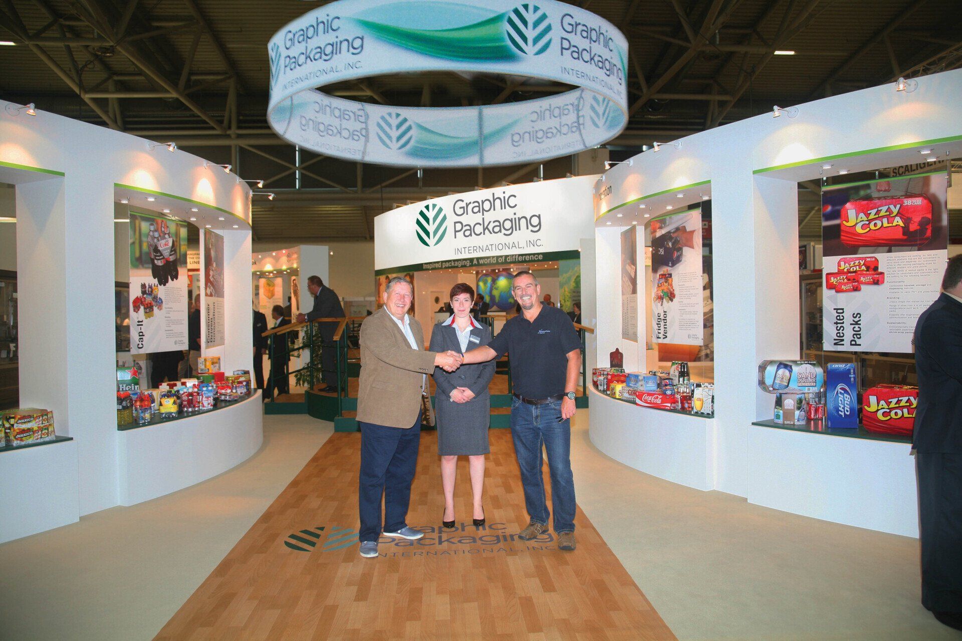 A group of people standing in front of a booth that says genetic packaging