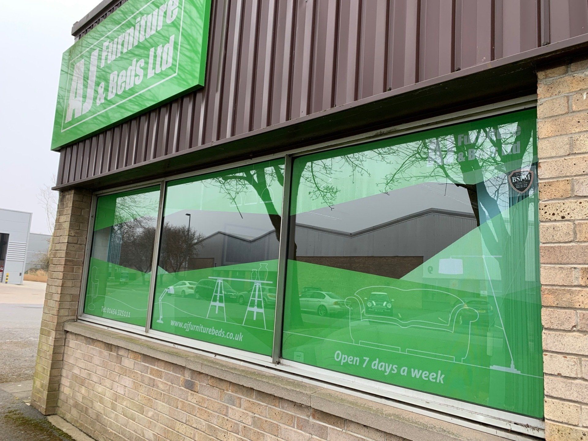 A building with a green sign on it and a lot of windows.