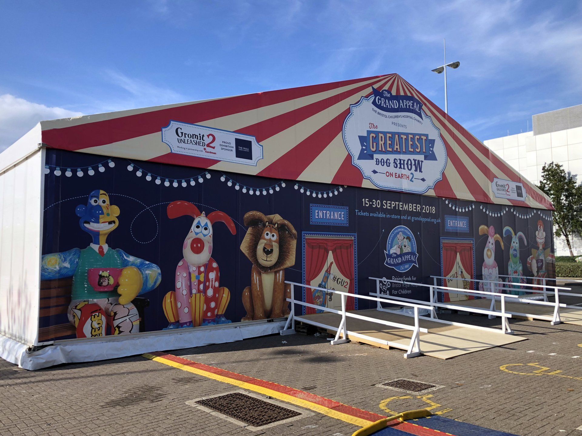A large circus tent with a large mural on the side of it.