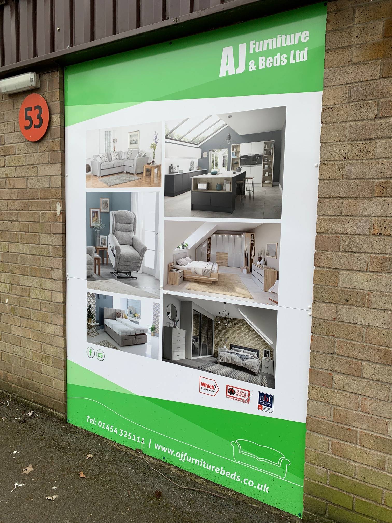 A large green and white advertisement for aj furniture and beds ltd
