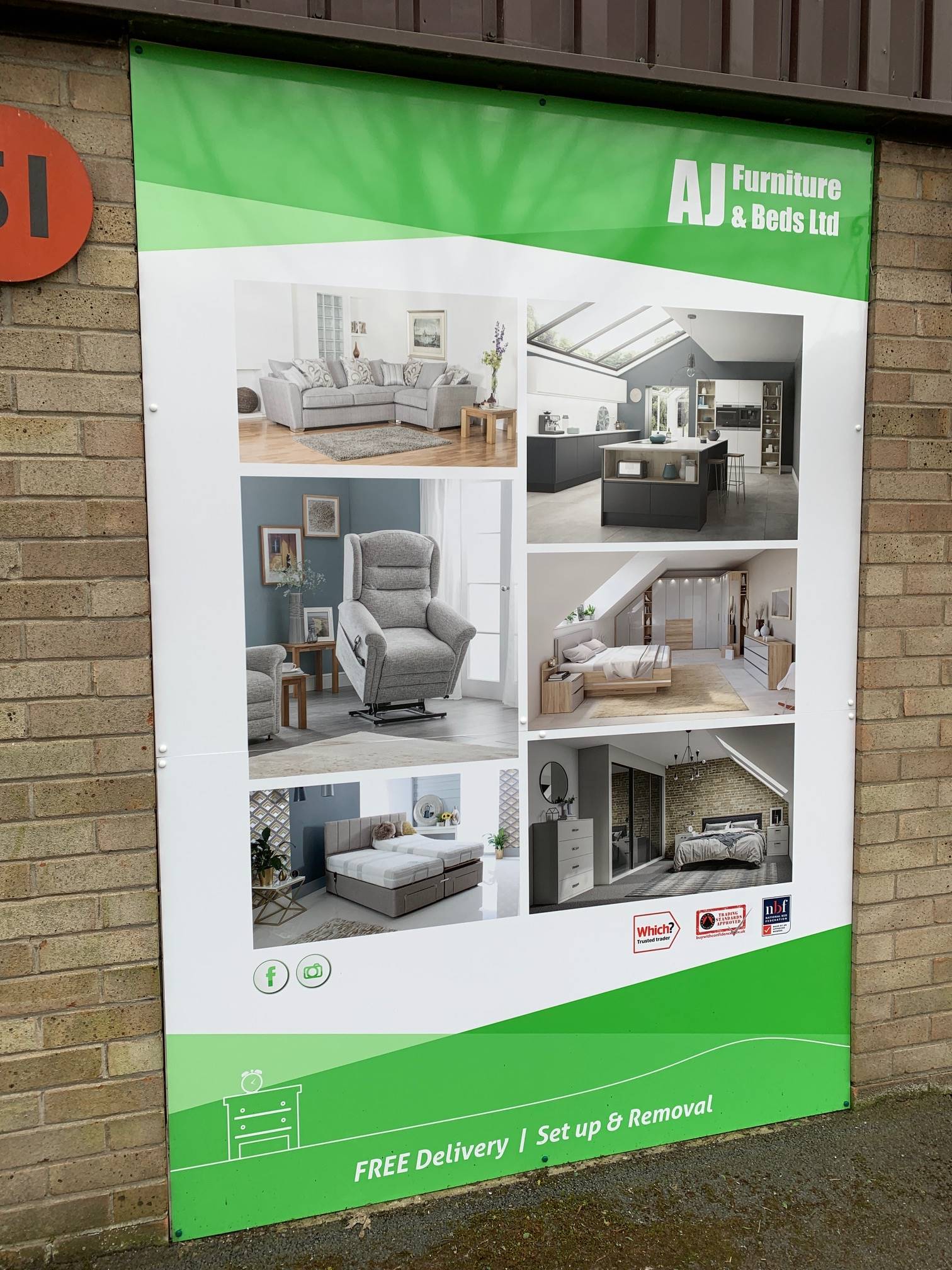 A large green and white poster is hanging on a brick wall.