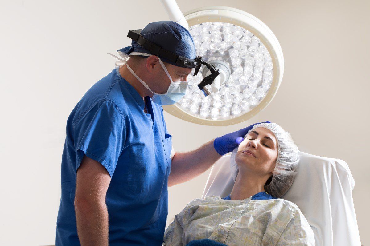 Doctor examining a patient under an operating room light