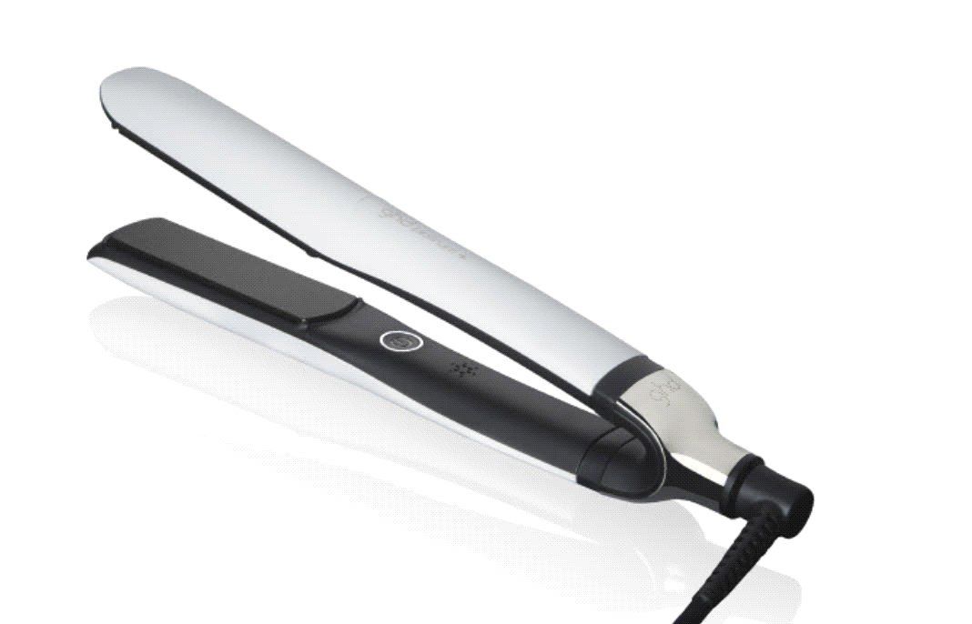 A black and silver hair straightener is sitting on a white surface.