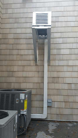 An air conditioner is installed on the side of a building.