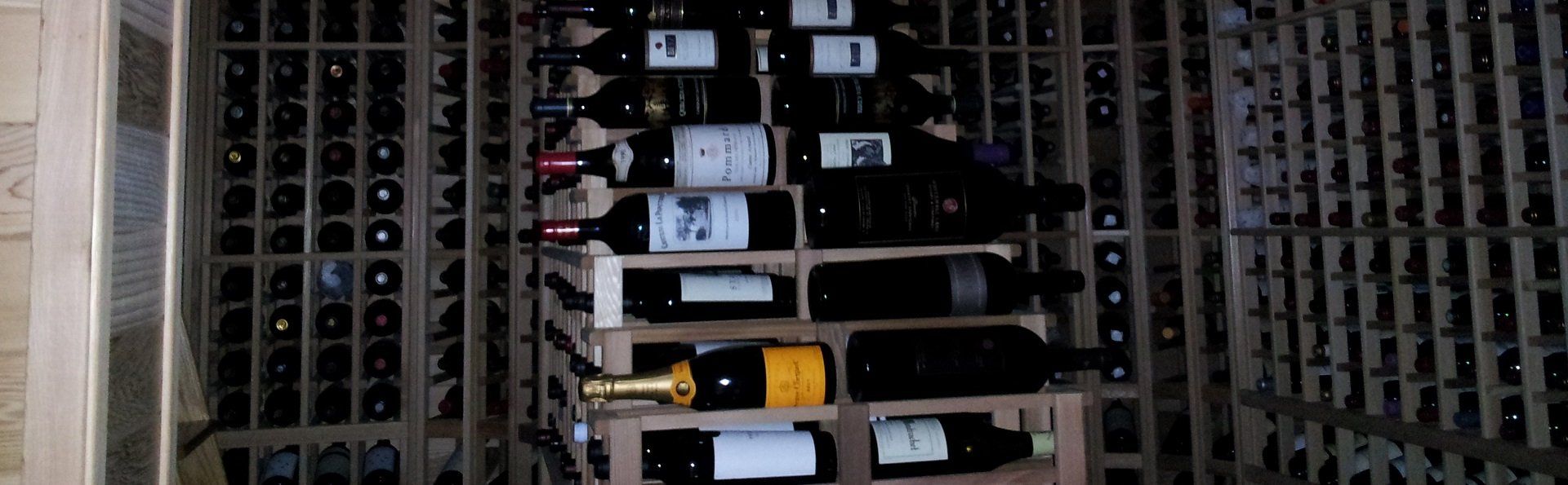 A row of wine bottles sitting on top of each other in a wine rack.