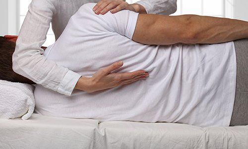 Massage Therapy — Man Having Chiropractic Back Adjustment in Brea, CA