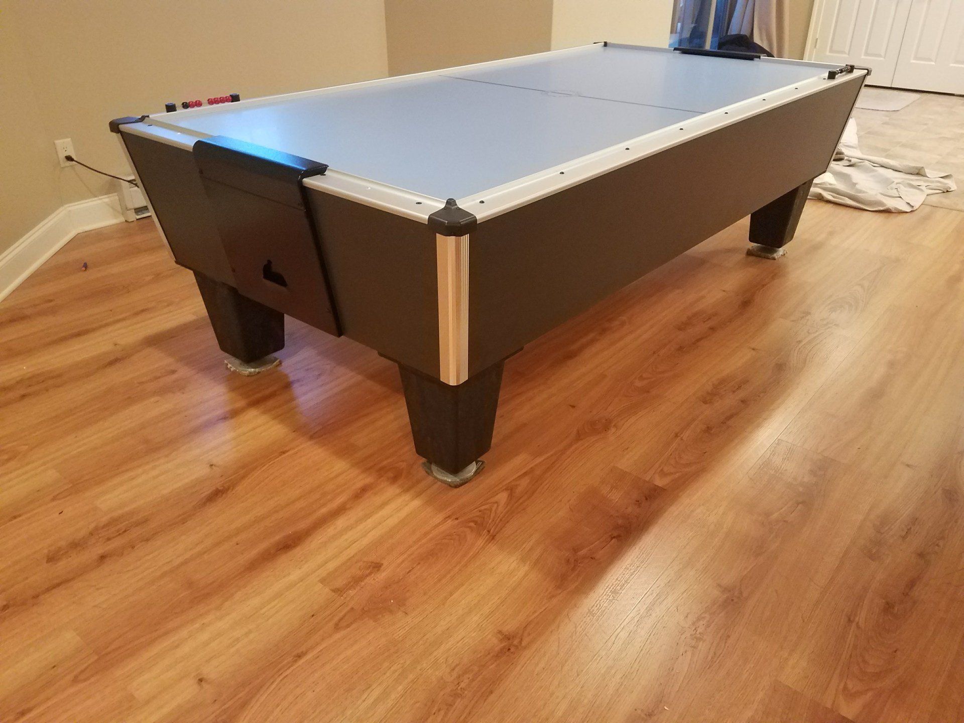 Blue air hockey table on wooden floor