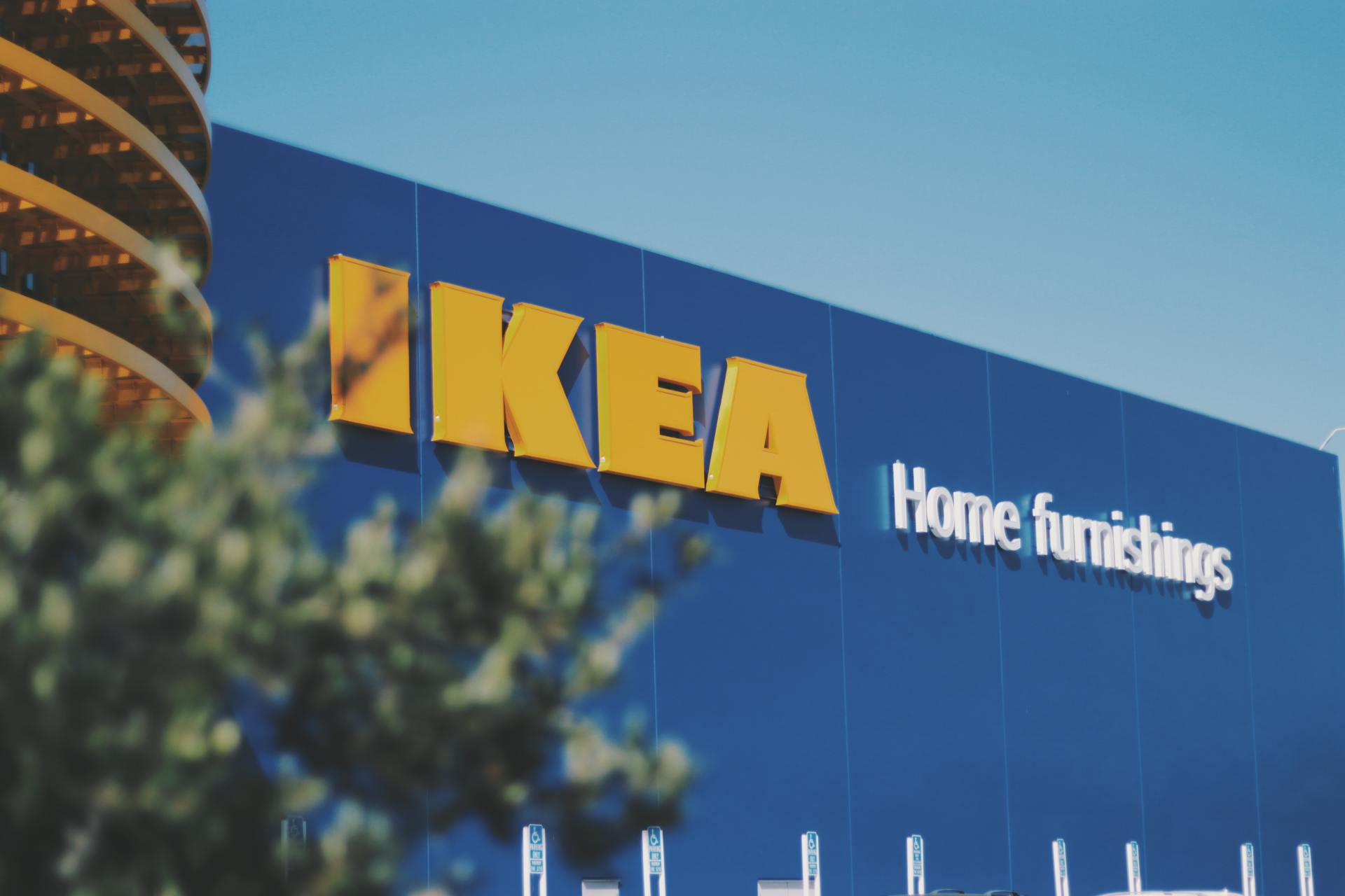IKEA store sign on a blue building, yellow letters, text 