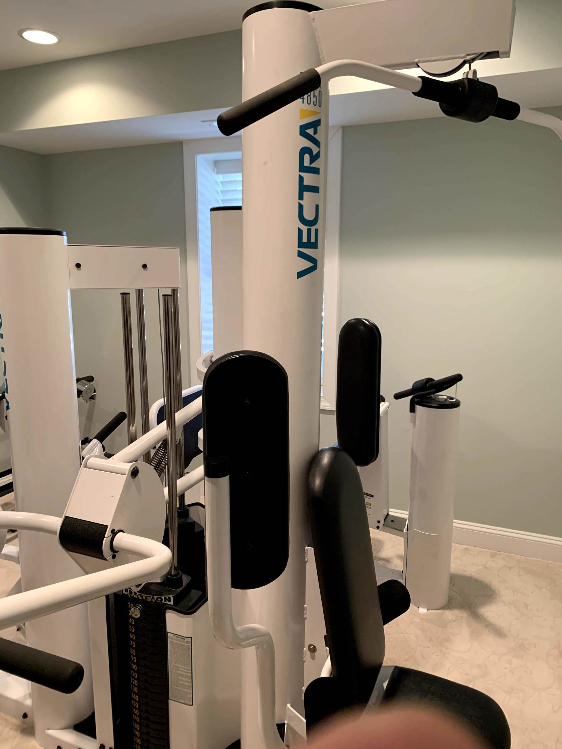 White Vectra fitness machine in a home gym setting.