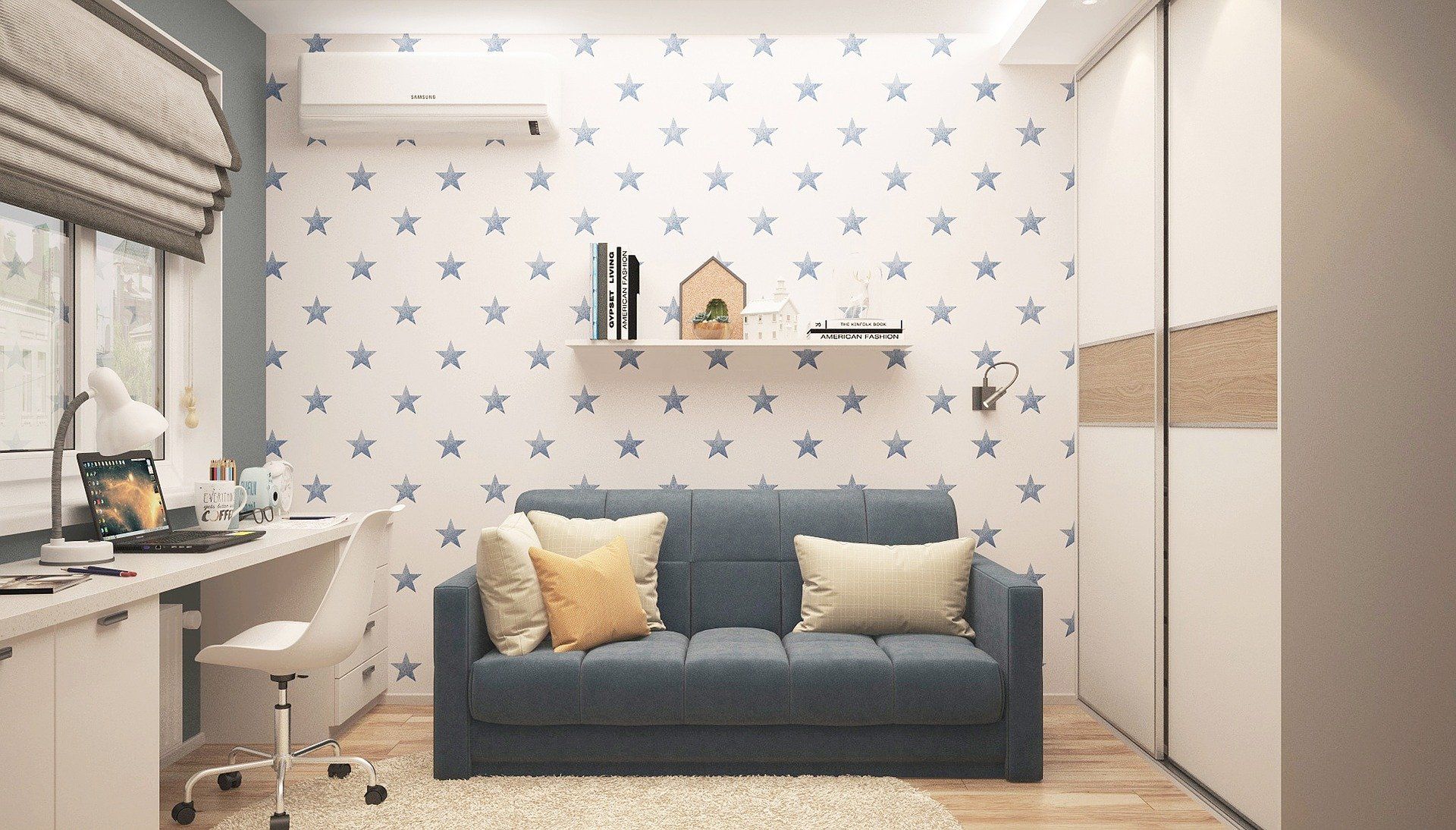 A cozy room with a blue sofa, star-patterned wall, desk, and a white closet.