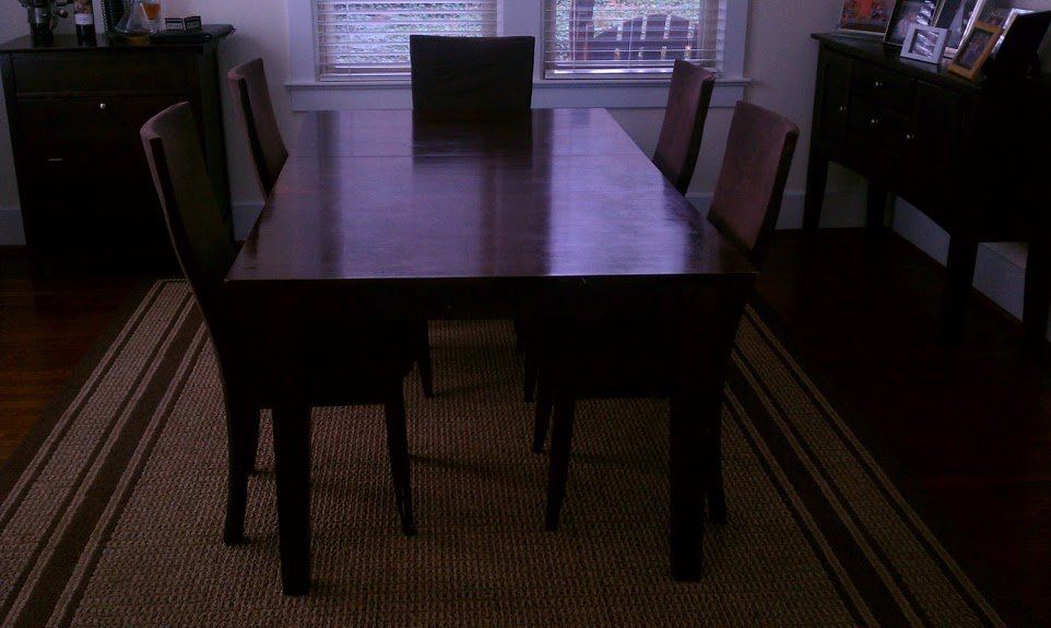 kitchen dining assembly of black hardwood table and chairs by furnitureassemblyteam