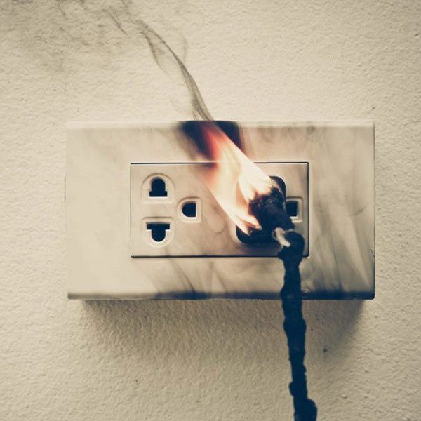 An electrical outlet with smoke coming out of it